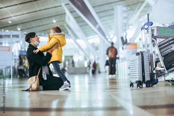 Fototapeta Happy woman meeting son at airport arrivals