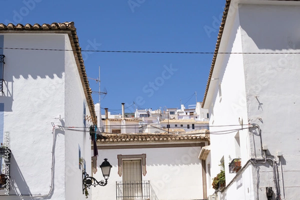 Fototapeta Typically Mediterranean, whitewashed residential buildings and terra cotta roof tiles in Altea, Alicante Spain