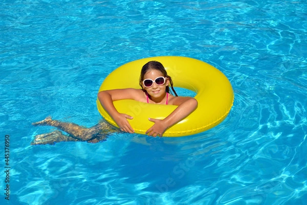 Fototapeta Real adorable girl relaxing in swimming pool