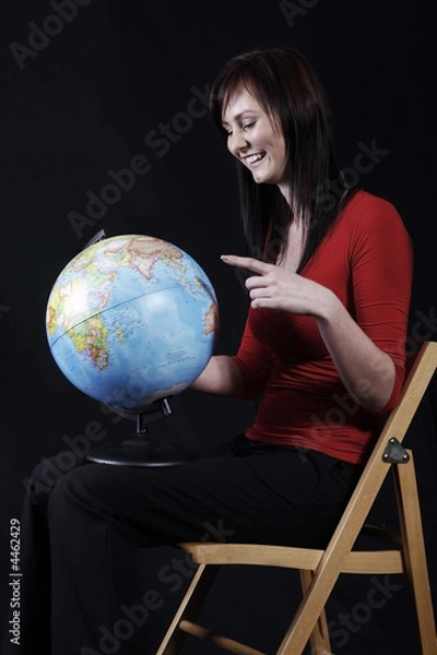 Fototapeta pretty girl looking at globe