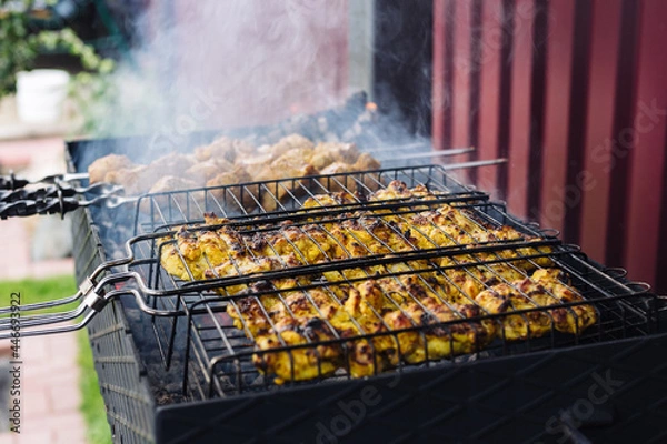 Fototapeta Chicken kebab is cooked on the grill