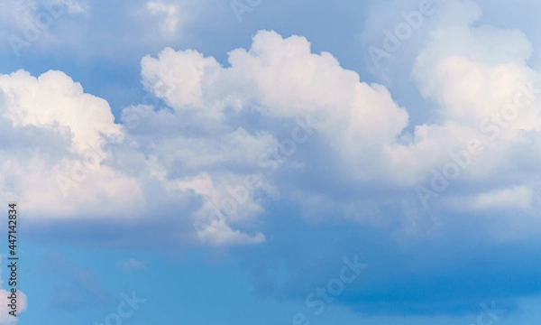 Fototapeta White, thick clouds on a background of blue sky, wallpaper.