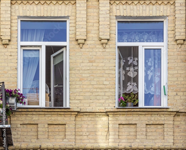 Fototapeta Two open windows in a town house.