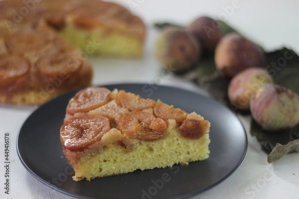 Fototapeta Slice of Fig upside down cake with lots of fresh figs and flavored with fresh orange juice.