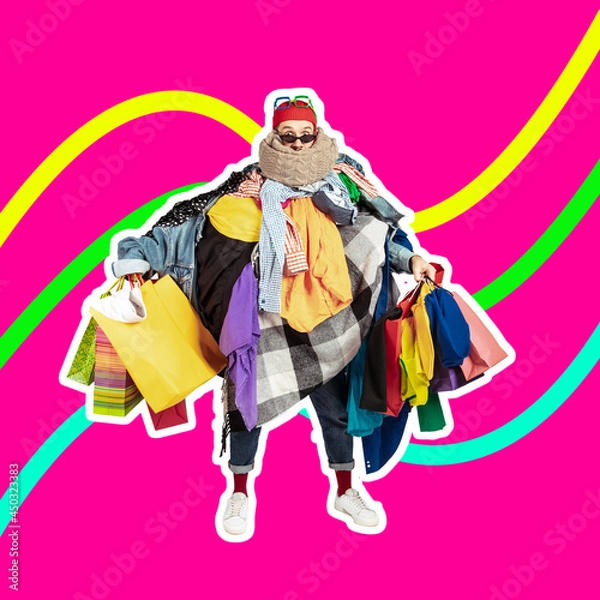 Obraz Sales concept. One young man dressed in many bright clothes holding a lot of paper bags. Black friday, fashion, ad concept