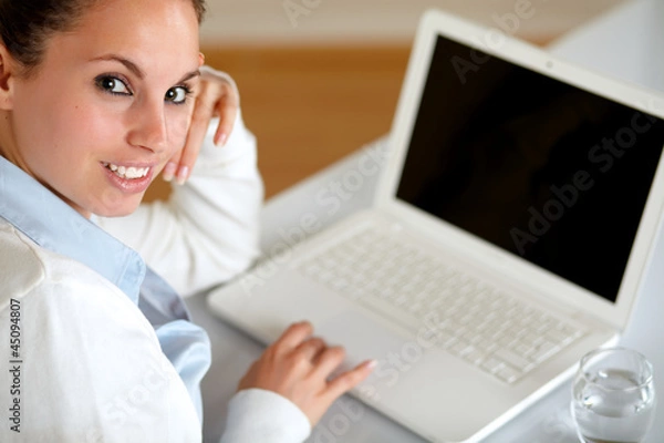 Fototapeta Young woman looking at you browsing the internet