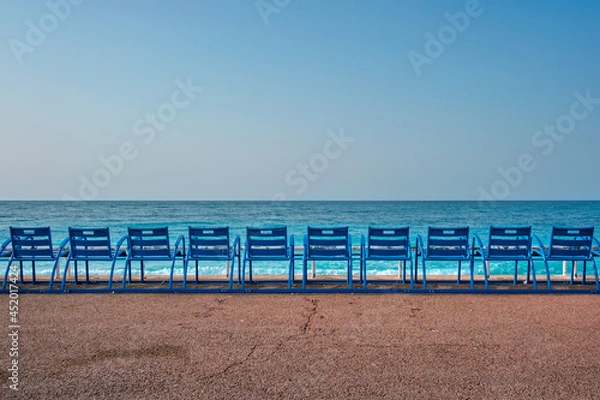 Fototapeta Famous blue chairs on beach of Nice, France