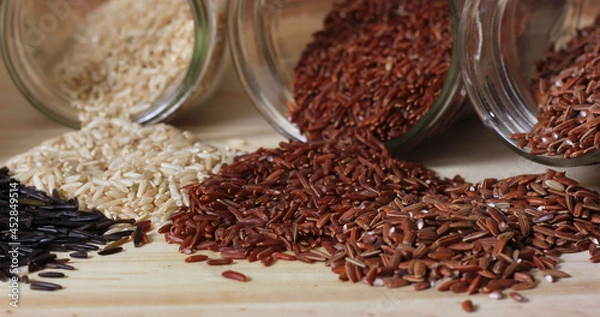 Fototapeta Black Wild Rice on Wooden Table with brown rice and Himalayan red rice