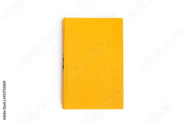 Fototapeta Yellow closed book with blank cover on white background