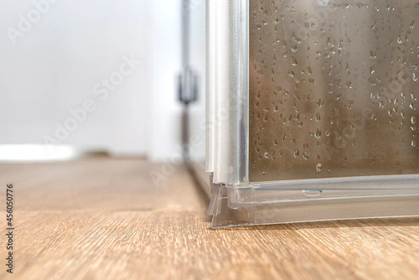 Fototapeta Seals in the lower part of the thresholdless shower enclosure, visible door corner..