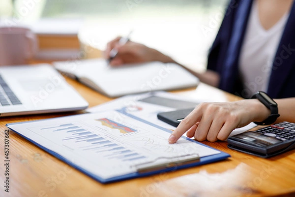 Fototapeta Close up of hand,Financial Businesswomen analyze the graph of the company's performance to create profits and growth, Market research reports and income statistics, Financial and Accounting concept.