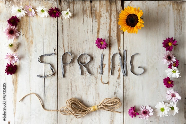 Fototapeta Spring beautiful rustic title with a frame full of flowers and a string on a white wooden background