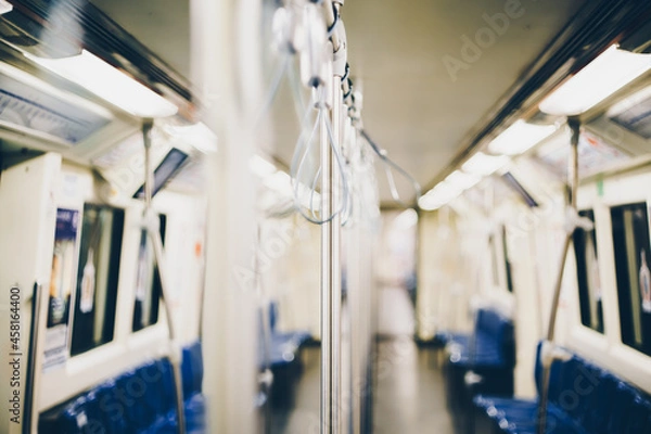 Fototapeta Selective focus on the holding hand pole in the empty metro train or subway as public transportation.