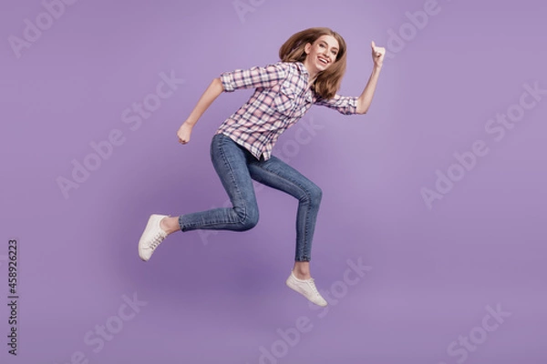 Fototapeta Full length side profile body size photo girl jump high go running sale discount isolated violet color background