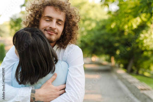 Fototapeta Happy young multiethnic couple in park