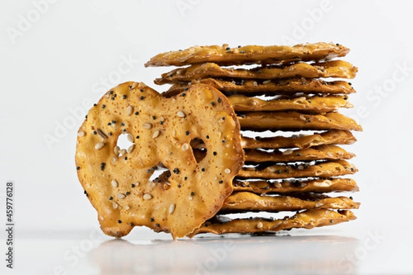 Fototapeta Focus stack of a stack of everything seasoned pretzel crackers on a white background