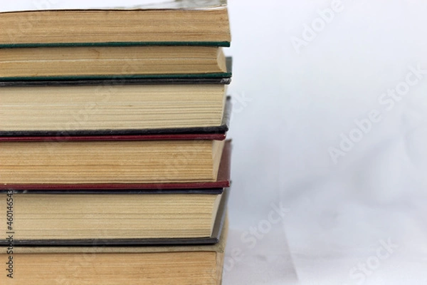 Fototapeta Heap of old old hardback books. Close-up of a stack of old used books