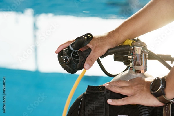 Fototapeta Male hands checking diving equipment before Dive.