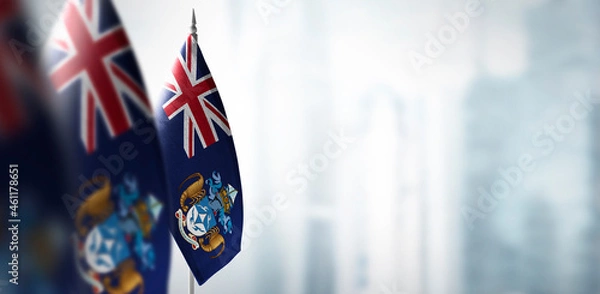 Fototapeta Small flags of Tristan da Cunha on a blurry background of the city