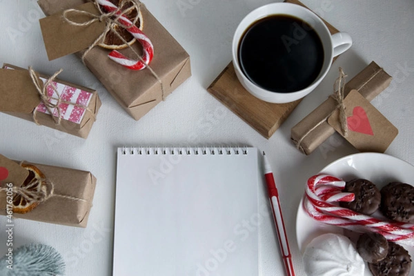 Fototapeta Notepad, coffee, christmas gifts, sweets on a light background