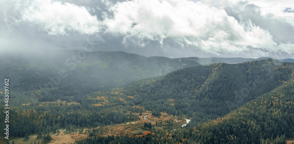 Fototapeta Panorama of mountain slopes in autumn colors and the river valley, natural autumn background. Bird's-eye view.