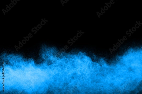 Fototapeta abstract blue powder splatted background,Freeze motion of color powder exploding/throwing color powder,color glitter texture on black background.