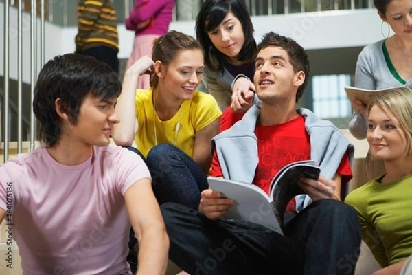 Fototapeta University students sitting on steps