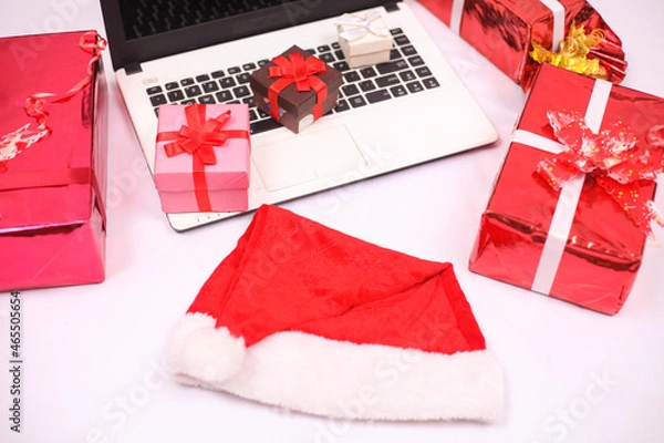 Fototapeta laptop and gifts for christmas and new year celebration isolated on white background