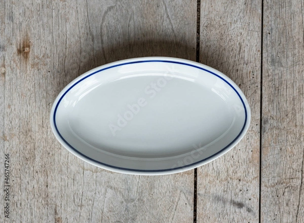 Fototapeta Vintage porcelain plate with a blue stripe - on a rustic wooden table