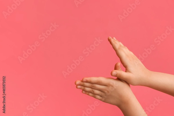 Fototapeta Child performing a shadow play on color background