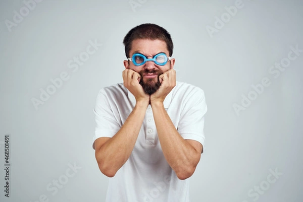 Fototapeta man wearing goggles for swimming emotions fun close-up