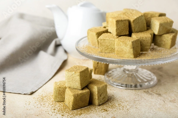 Fototapeta Stand with tasty hojicha marshmallows on light table