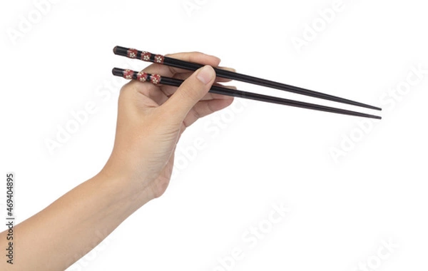 Fototapeta Hand holding Wooden chopsticks isolated on white background