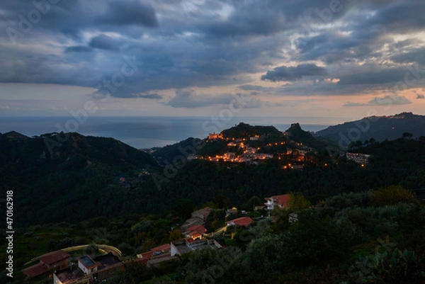 Fototapeta the village of savoca and nearby hamlets overlook the ionian sea in the first shadows of the night