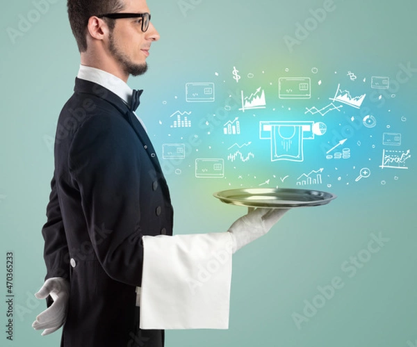 Fototapeta Handsome young waiter in tuxedo holding money icons on tray