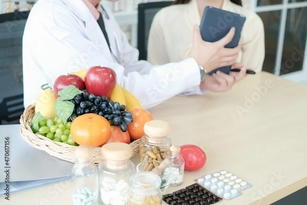 Fototapeta Professional nutritionist asian man consulting asia woman in clinic or hospital or medical club