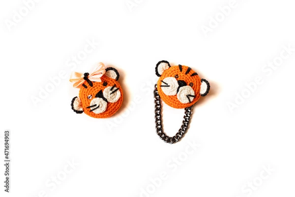 Fototapeta Handmade knitted soft toy. Two littlestripes tiger on the white background. Crochet and knitting stuffed animals.