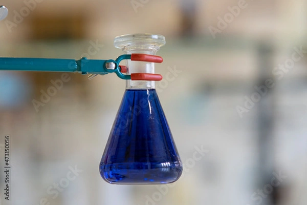 Fototapeta Blue chemical solution inside flask.