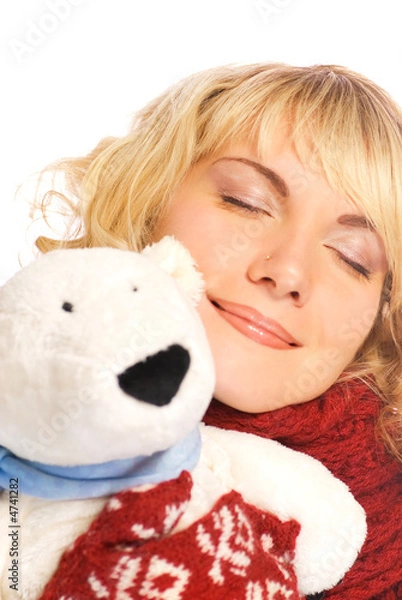 Fototapeta Beautiful blond girl in winter clothing with a white polar bear