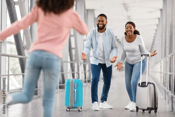 Fototapeta Happy black family meeting running kid in airport