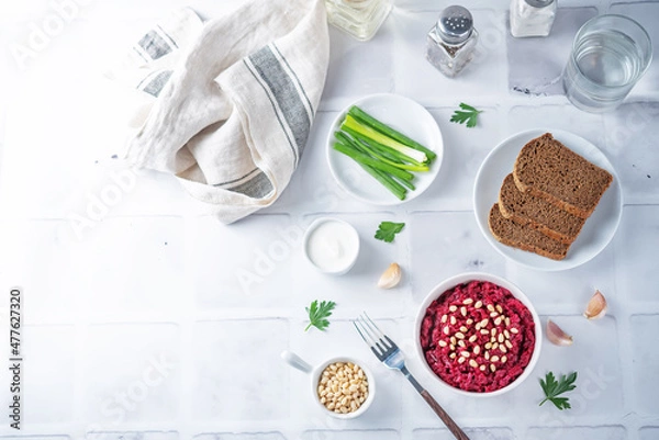 Fototapeta Beetroot salad with pine nuts in a bowl