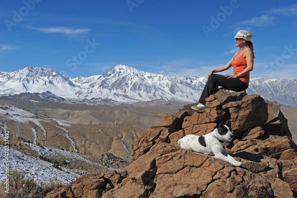 Fototapeta Woman and dog rest on rocky overlook, Inyo National Forest, CA