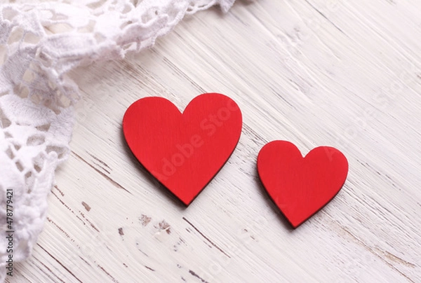 Obraz Two red hearts on a white wooden background. Valentine's Day