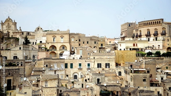 Fototapeta ITALY-Matera is a city located on a rocky outcrop in Basilicata, in Southern Italy. It includes the Sassi area, a complex of Cave Houses carved into the mountain