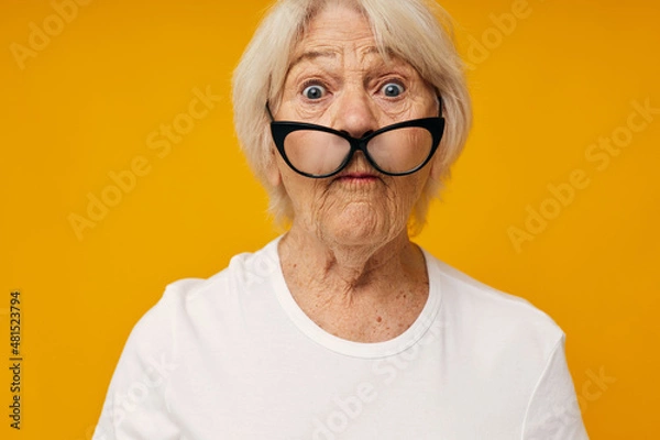 Fototapeta Photo of retired old lady vision problems with glasses close-up emotions