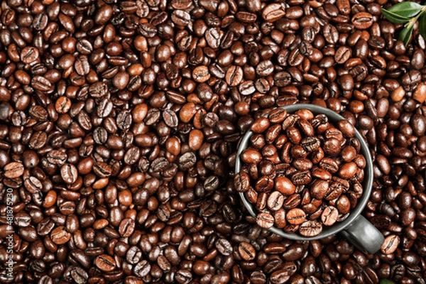 Fototapeta Coffee background with space for text, layout of coffee beans on the table and black cup for espresso coffee, coffee advertising idea