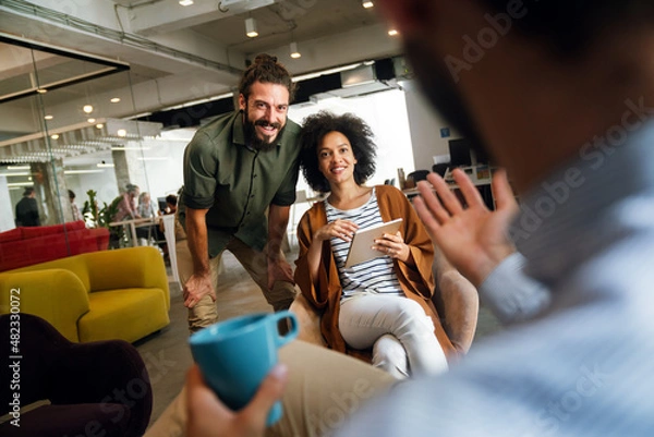 Fototapeta Portrait of success business colleagues working, smiling together in office.