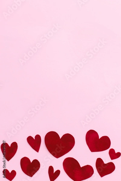 Fototapeta Happy Valentine's Day! Stylish valentine hearts flat lay on pink background with space for text. Valentines day card template. Cute red velvet hearts cut outs on pink paper. Love concept