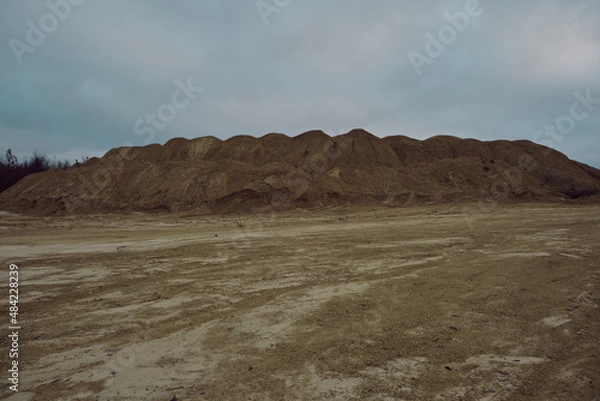 Fototapeta sand quarry with water in late autumn evening