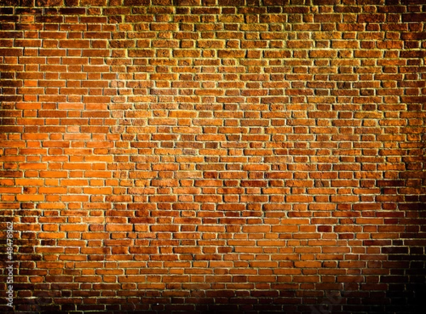 Fototapeta Grungy textured red stone wall inside old neglected and deserted